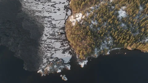 Aerial Top Down Drone Shot Of Frozen Lakeside During Sunset In Finland Stock Footage 224302327