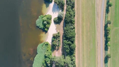 Aerial top down drone shot of a lake and a beach in Zeewolde, The Netherlands Stock Footage 232721953