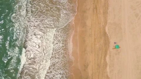 Aerial top down drone shot of ocean tides, big ocean tides at beach Stock Footage 296674922