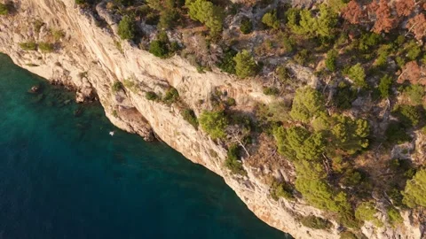 Aerial Top-Down Drone Shot: Diagonal Split of Cliff and Sea at Golden Hour in Cr Video stock 320145922