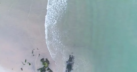 Aerial top down drone shot of a beautiful empty beach with calm turquoise wav Stock-Footage 327953284