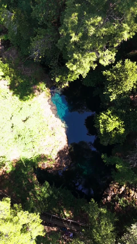 Aerial top-down drone shot descending towards a stunning hidden blue lagoon.. Stock Footage 339210528