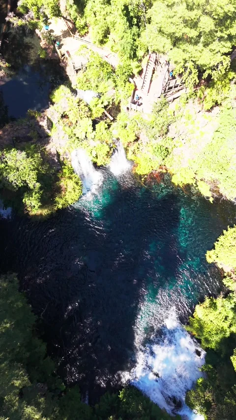 Aerial top-down drone shot descending towards a stunning hidden blue lagoon.. Stock Footage 339210591