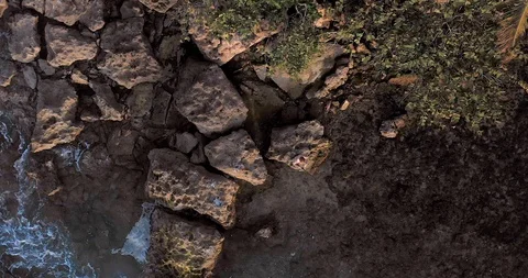 Aerial top down drone view of an aninymous man fishing on the rocky Atlantic Stock Footage 124753576