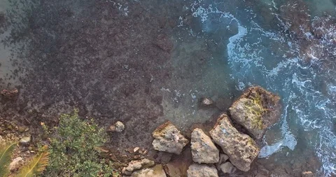 Aerial top down drone view of an aninymous man fishing on the rocky Atlantic Stock Footage 124753695