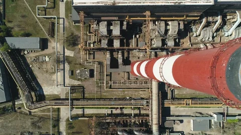 Aerial top down drone view of large red and white chimney without smoke at sunny Vidéo 129972896