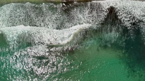 Aerial top down drone view of sea waves crashing near the beach shore Stock Footage 278794316