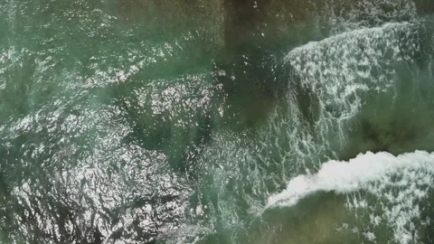 Aerial top down drone view of sea waves crashing near the beach shore Stock Footage 278794768