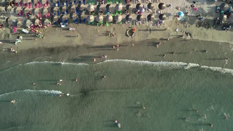 Aerial top down drone view of people at the beach having fun Stock Footage 278796107