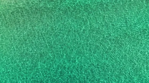 Aerial top down drone view of waves in turquoise transparent sea water Stock Footage 279582026