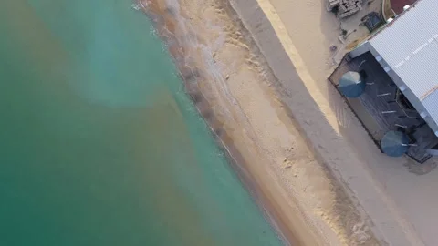 Aerial top-down drone view of sandy beach and turquoise coastline Stock Footage 322537146