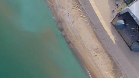 Aerial top-down drone view of sandy beach and turquoise coastline Stock Footage 322537148