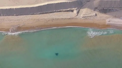Aerial top-down drone view of sandy beach and turquoise sea Stock Footage 322537498