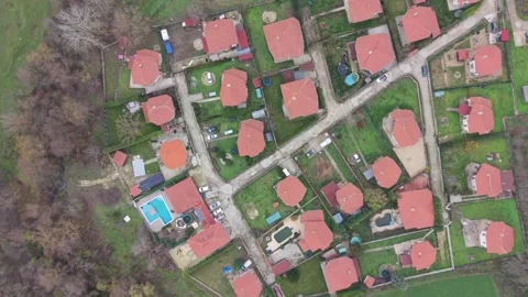 Aerial top-down drone view of suburban houses with red rooftops Stock Footage 323321569