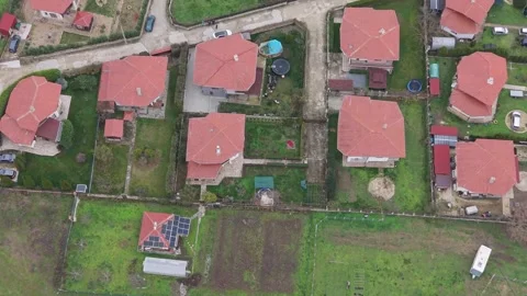 Aerial top-down drone view of suburban houses with red rooftops Stock Footage 323321590