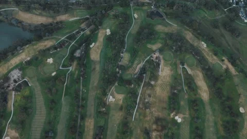 Aerial top-down drone view of a golf course with green fairways Vídeos de archivo 342573649
