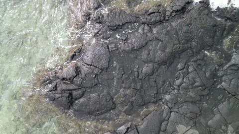 Aerial top-down drone view of ocean waves washing in Hawaii 動画素材 347825755