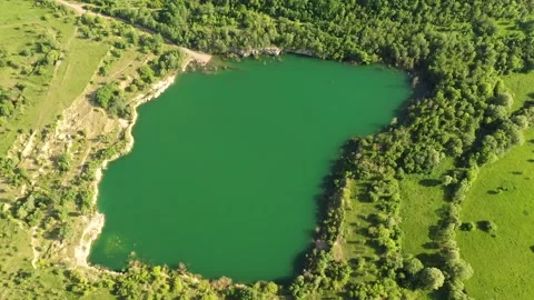 Aerial top down flight over amazing small lake of perfectly round shape. Clear Stock Footage 145331258