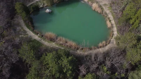Aerial top down flight over amazing small lake in park near mountains. Stock Stock Footage 168410347