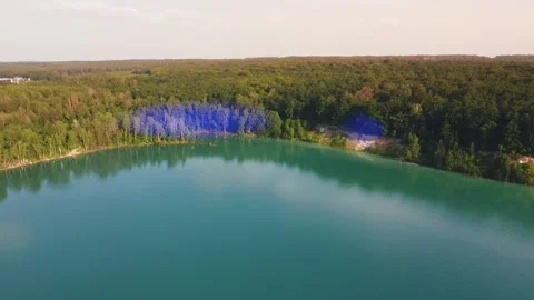 Aerial top down flight over amazing small lake of perfectly round shape. Video stock 204872771