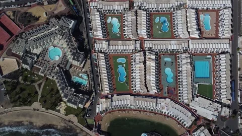 Aerial top down flight over resort hotel swimming pools 4k Stock Footage 278650830