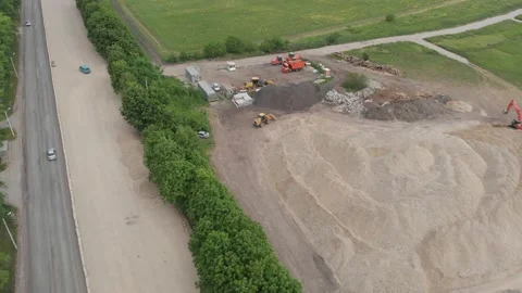 Aerial Top Down Fly over on construction equipment engaged in road repair Stock Footage 145556998
