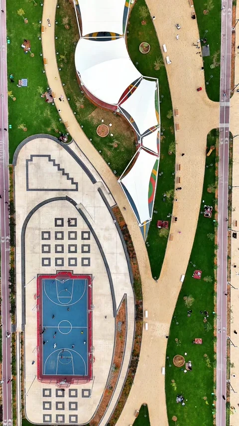 Aerial top-down flying over a park including basketball court and walking paths Stock Footage 331031859