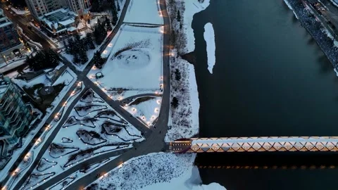 Aerial Top-Down Flyover of Peace Bridge and Eau Claire Park Calgary Stock Footage 333548725