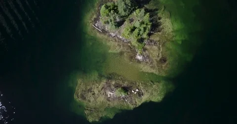 Aerial top down flyover of small island in a lake Stock Footage 79822930