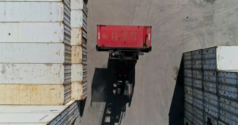 Aerial, Top down: Forklift transporting and packing a shipping container Stock Footage 236547560