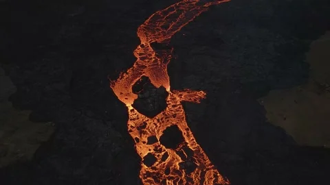 Aerial top-down forward over lava river flowing along black volcanic Video stock 154005501