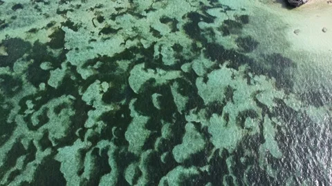 Aerial top down forward over Geger Beach water 스톡 동영상 329077474