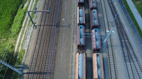 Aerial top down of freight train loaded with crushed stone Видео 339271873