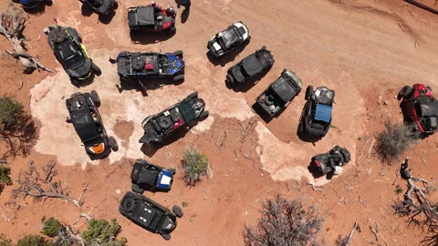 Aerial-Top down-Group of parked off road vehicles in the desert Stock Footage 274325104