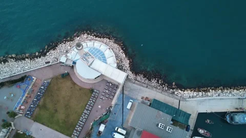 Aerial top down of lighthouse with cafe playground and sea pier Stock Footage 338105654