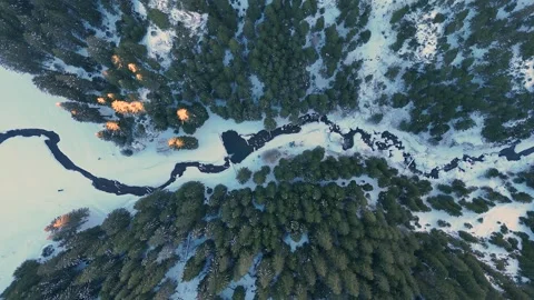 Aerial top down mountain landscape view of a winding river in the winter season Stock Footage 296697402
