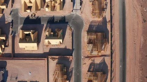 Aerial top down moving shot of wooden residential construction in Vegas desert Stock Footage 201158855