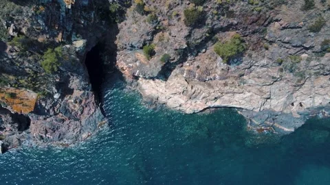 Aerial top down nature view of rocks in the blue Mediterranean Sea in Palam.. Video stock 246296436