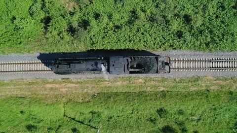 Aerial top down of an old steam locomotive standing on the railway. Retro steam Video stock 252283053