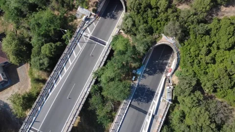 Aerial top-down orbit view of highway bridge and mountain tunnel Stock Footage 343961845