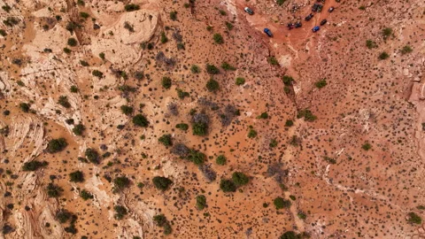 Aerial-Top down over desert to view string of off road vehicles Stock Footage 273534618