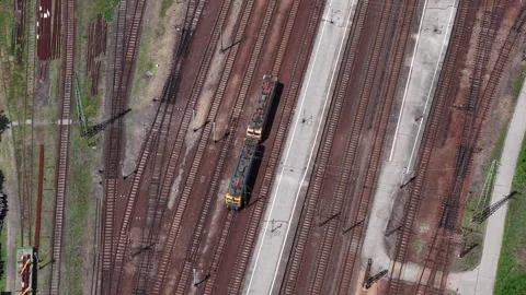 An aerial top-down perspective shows a locomotive navigating a complex network Stock Footage 337945007