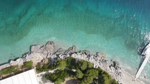 Aerial top-down rise over crystal clear sea beach Stock Footage 336601517