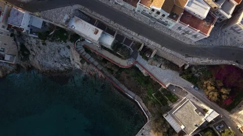 Aerial top down Rotating Ascend Over Vaporia Coastal Stairs in Syros Ermoupol Stock Footage 334557577