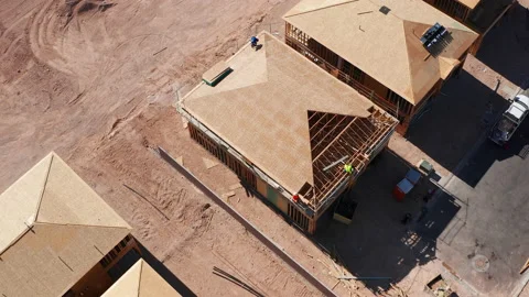 Aerial top down rotating shot of workers building roofs in new house in Vegas Stock Footage 200529831