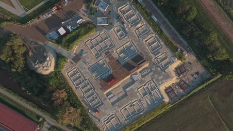 Aerial top down rotating view of housing construction site foundation Stock Footage 342812668