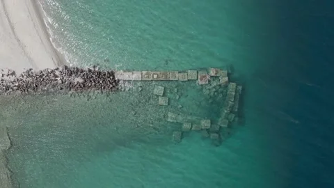 Aerial top down shoot of rocks at a beach with blue water summer 4K  60FPS Stock Footage 237141106