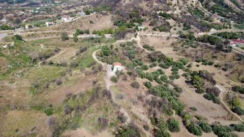 Aerial top down shot of agricultural land with a chapel and olive grove Stock Footage 344105403