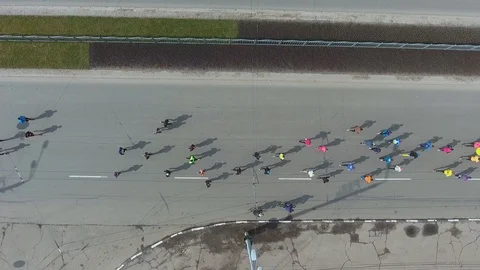 Aerial top down shot of athletic people at running marathon on city road Video stock 105178742