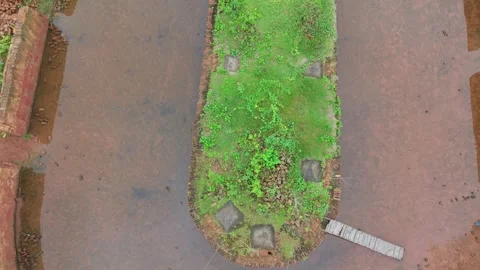 Aerial top down shot of a brick kiln chimney in a green countryside landscape Stock Footage 341541474